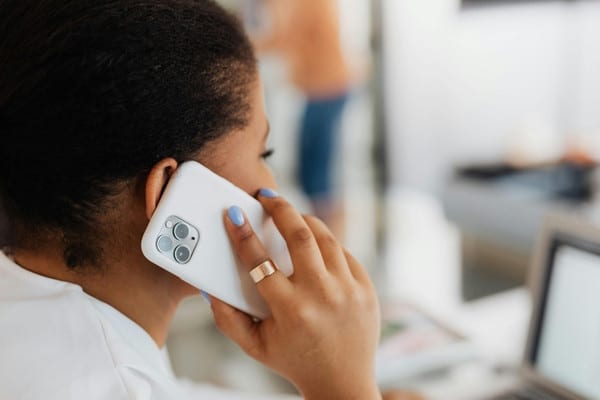 Woman calling to schedule a tree service consultation on her phone.